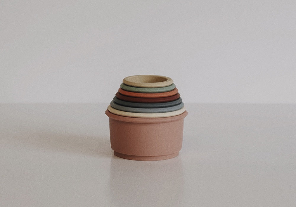 Beehive Stacking Cups in vibrant colors, designed for sensory play and skill development.