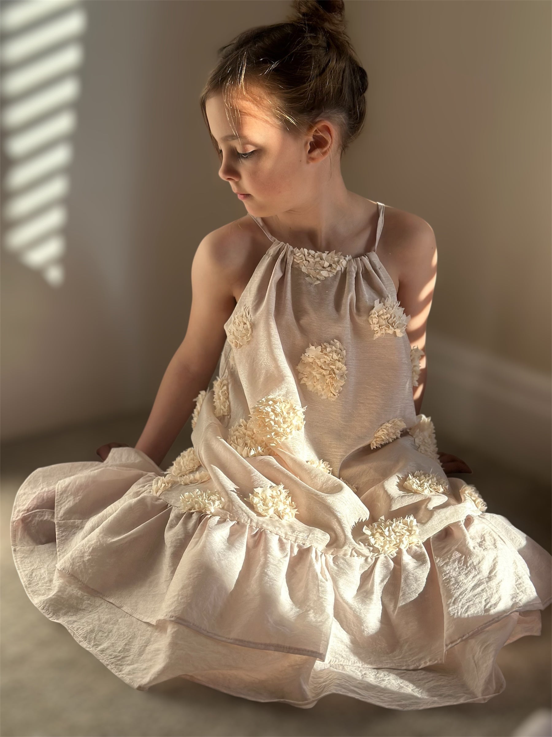 Blush pink halter neck dress with 3D floral design for girls, featuring an oversized and floaty silhouette.