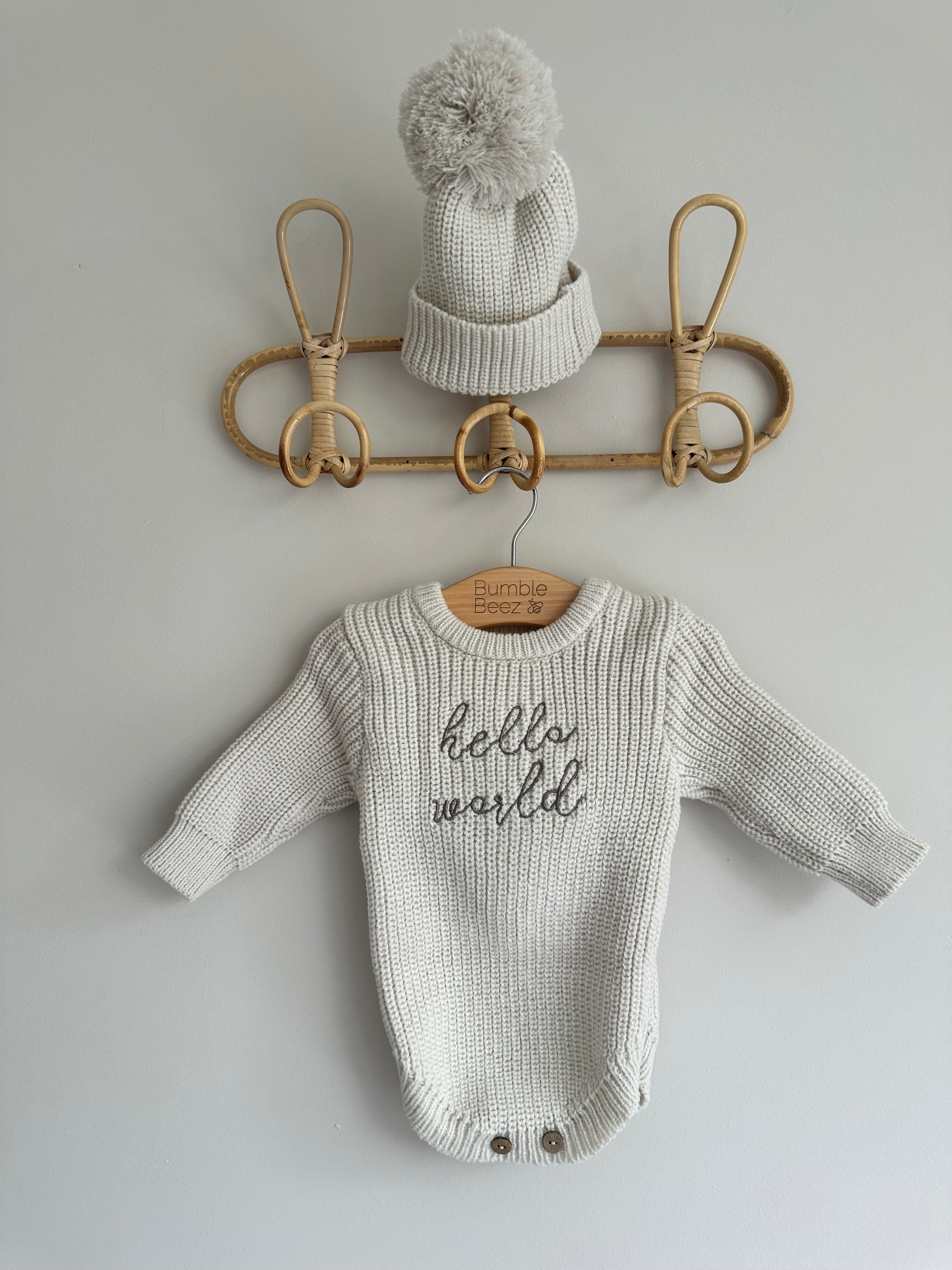 Beige knitted 'Hello World' romper with bobble hat for babies, size 0-3 months.