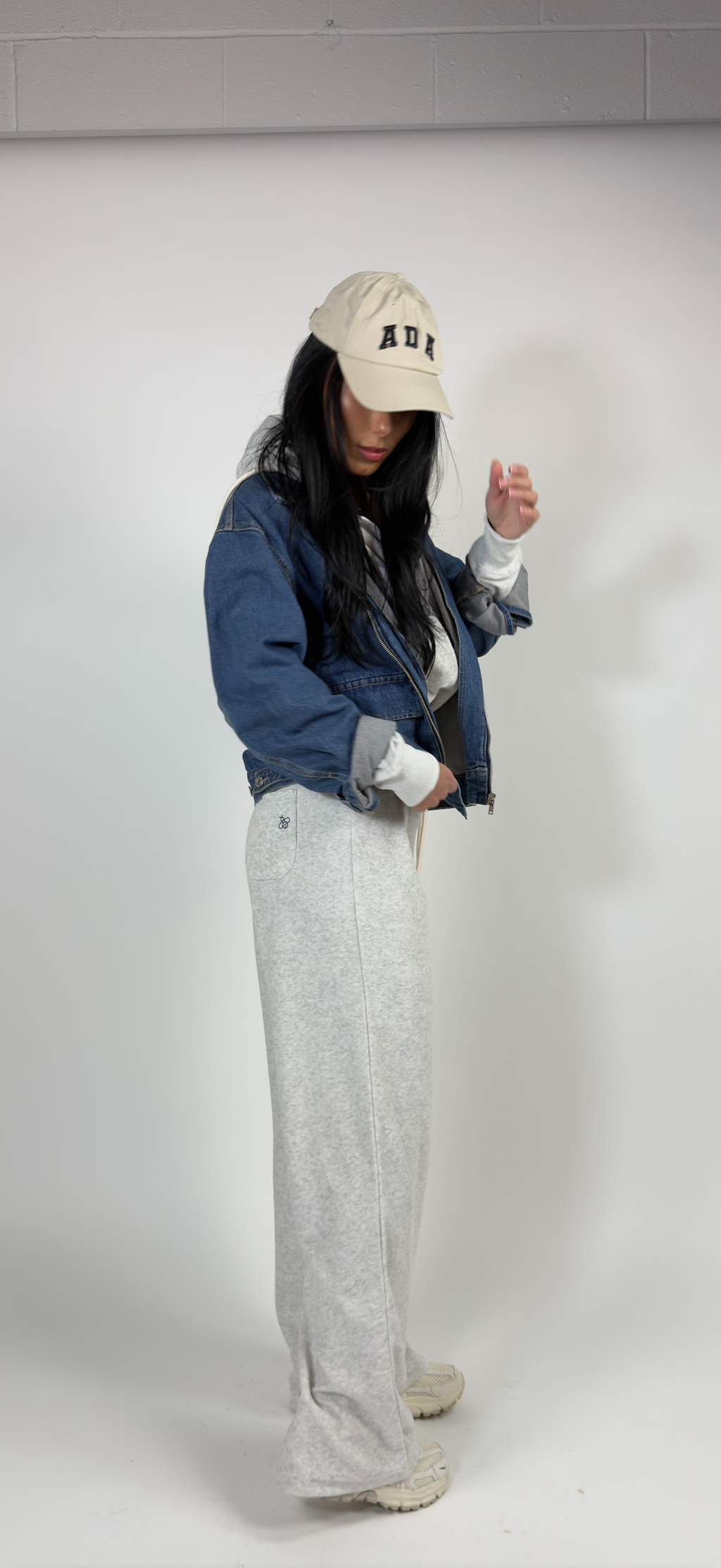 Light grey towelling tracksuit with zip-up hoodie and drawstring trousers featuring navy logo on pocket