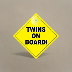Bright yellow Twins On Board car sign with suction cup for window attachment and black lettering for visibility