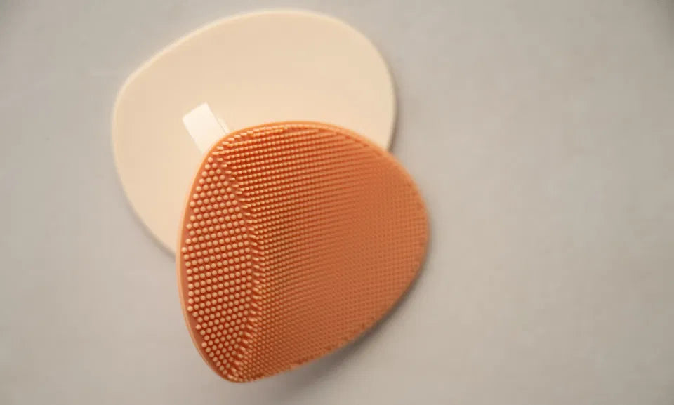 The Gentle Touch silicone baby bath brush in cinnamon color with soft bristles and suction handle for cradle cap prevention and gentle cleansing