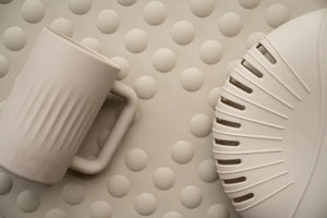 Soft beige Soft Pour Rinse Jug made of baby-safe silicone with ergonomic handle for gentle, controlled pouring during bath time