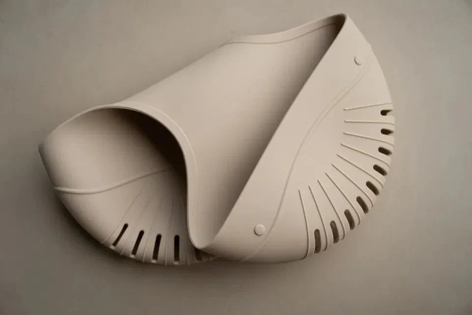 The Drift Bath Organiser in soft beige silicone with perforated drainage and dual compartments for baby bath essentials