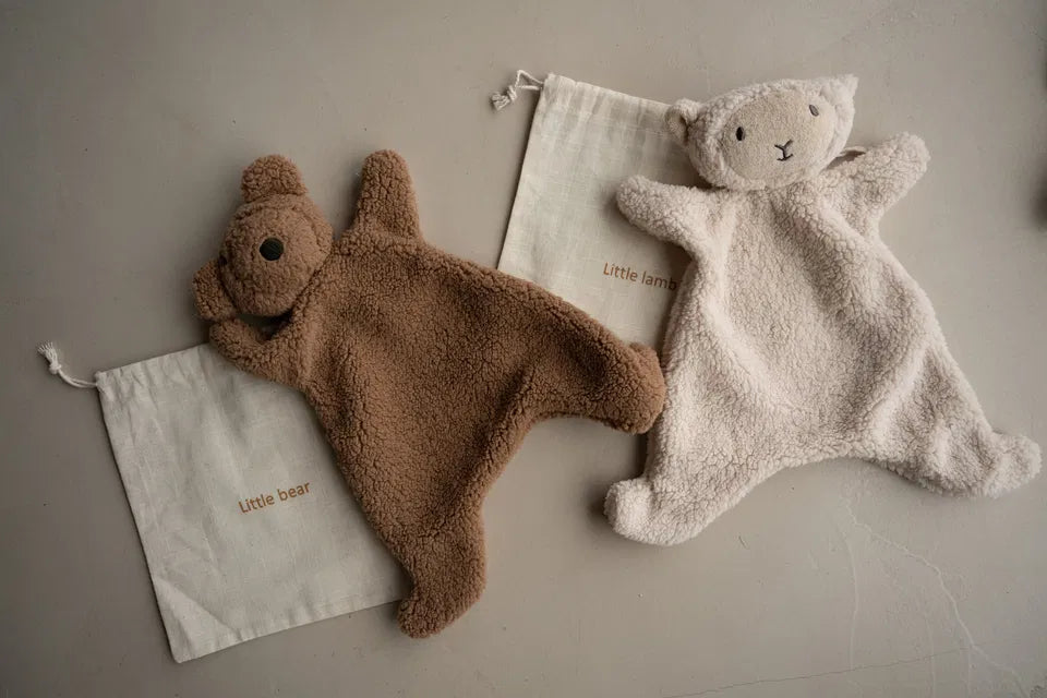 The Little Snuggler plush baby comforters in bear and lamb styles made of soft faux lamb wool