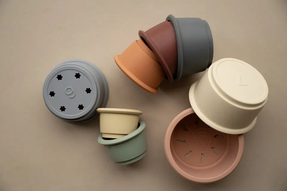 Soft silicone stacking cups in muted multi colors for baby sensory and motor skill development