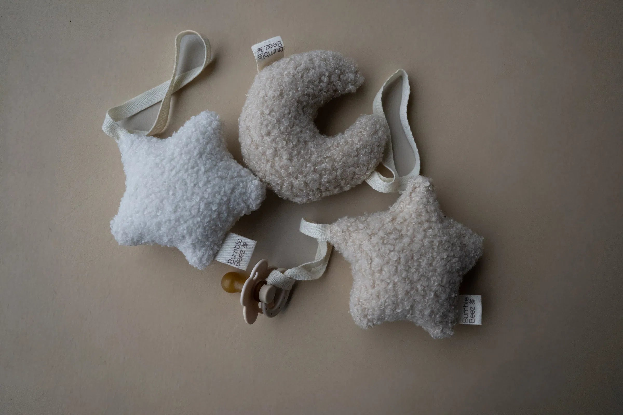 Sensory Moon And Stars soft boucle fabric baby toy in Milk and Biscuit with pacifier clip and nursery hanging option